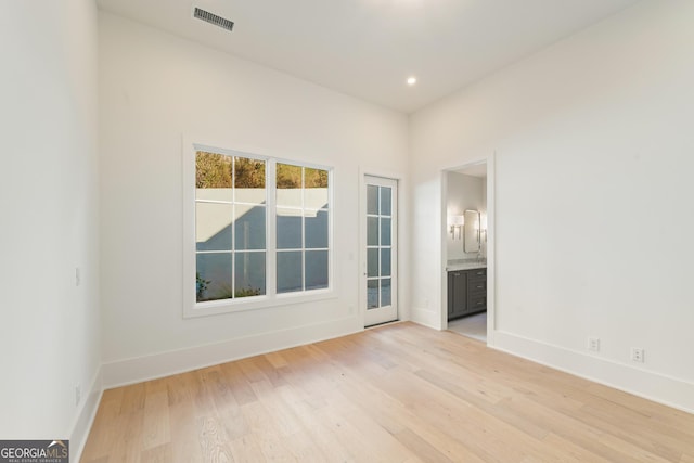 spare room featuring visible vents, recessed lighting, light wood-type flooring, and baseboards