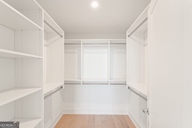 walk in closet featuring light hardwood / wood-style flooring