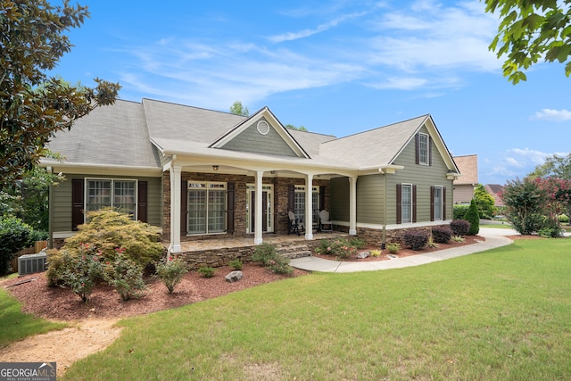 view of front of home featuring a porch, central AC, and a front yard