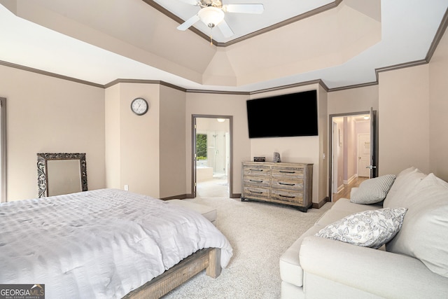 carpeted bedroom with ensuite bathroom, a raised ceiling, ceiling fan, and crown molding