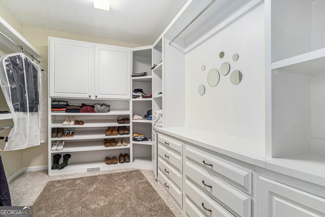 walk in closet with carpet