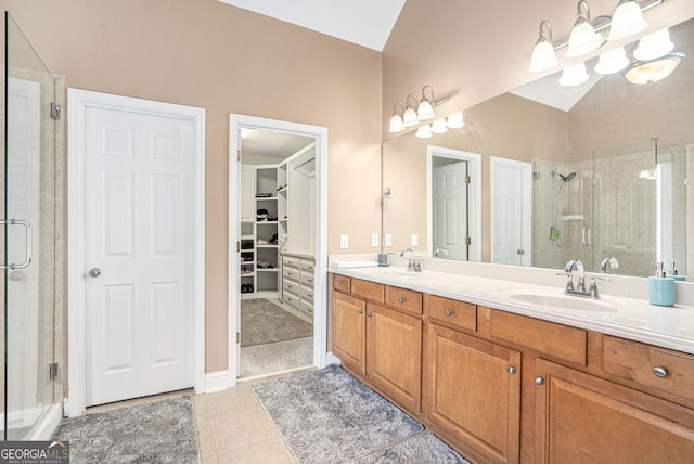 bathroom featuring vanity, tile patterned floors, and a shower with shower door