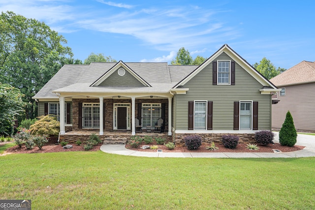 view of front of property with a front yard and covered porch