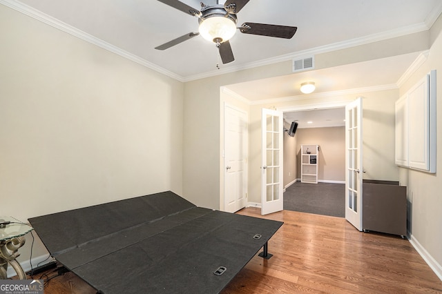 bedroom featuring crown molding, french doors, ceiling fan, and light hardwood / wood-style flooring