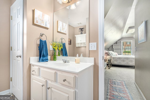 bathroom featuring vanity and lofted ceiling