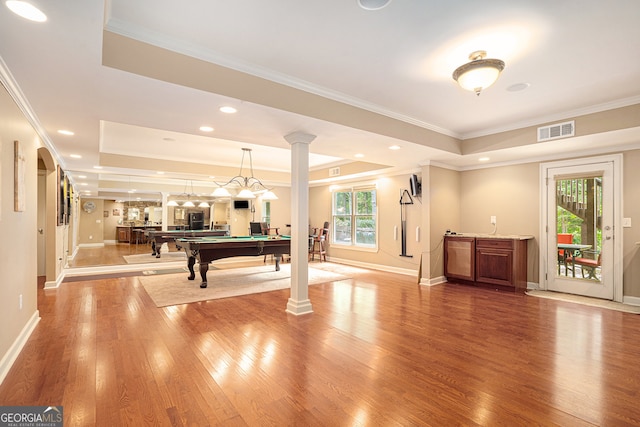 rec room with plenty of natural light, hardwood / wood-style floors, and a raised ceiling