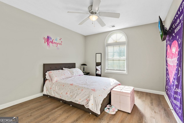 bedroom with ceiling fan and dark wood-type flooring