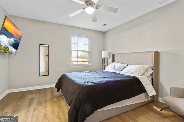 bedroom with ceiling fan and hardwood / wood-style flooring