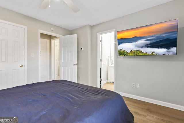 bedroom with ceiling fan, hardwood / wood-style flooring, and ensuite bathroom