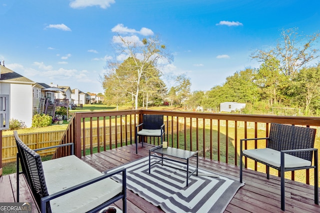 wooden terrace with a lawn