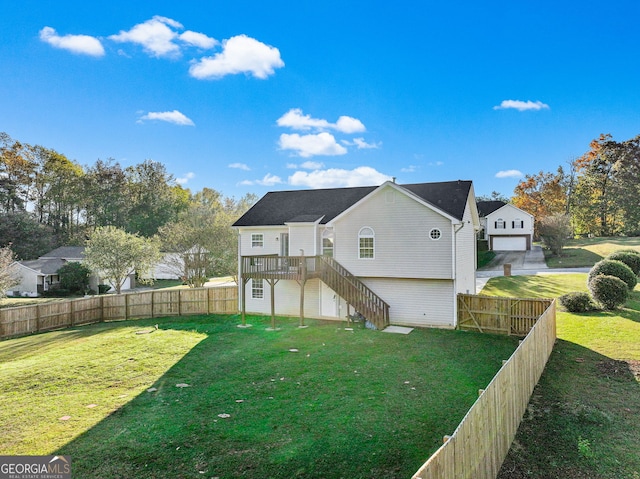 back of property featuring a wooden deck and a yard