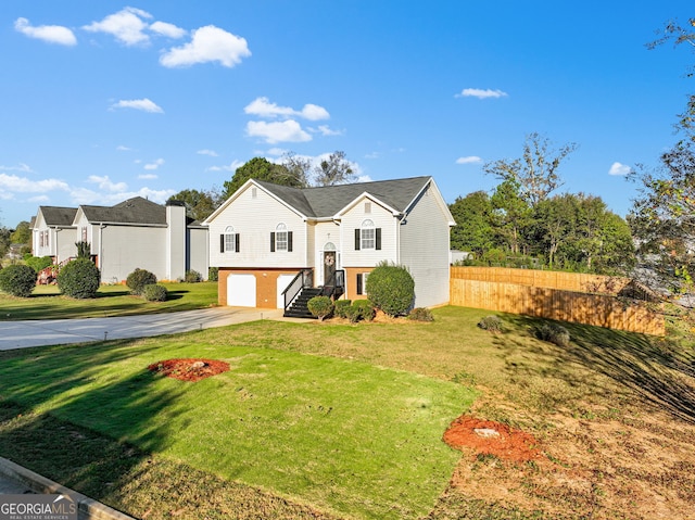 raised ranch with a front yard and a garage