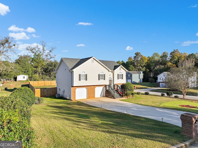 view of front of home with a front lawn and a garage