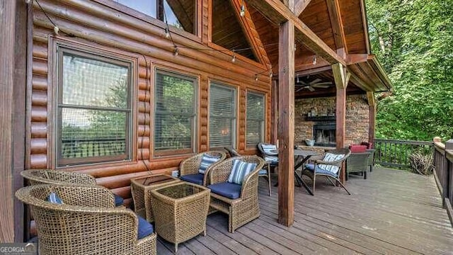 wooden deck with a stone fireplace