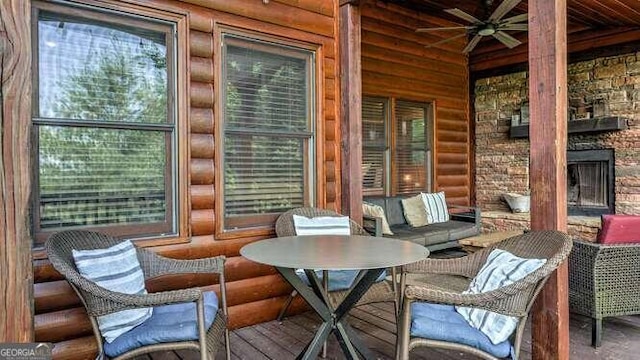 sunroom featuring a fireplace, plenty of natural light, and ceiling fan