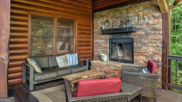 exterior space with rustic walls, hardwood / wood-style floors, and an outdoor stone fireplace