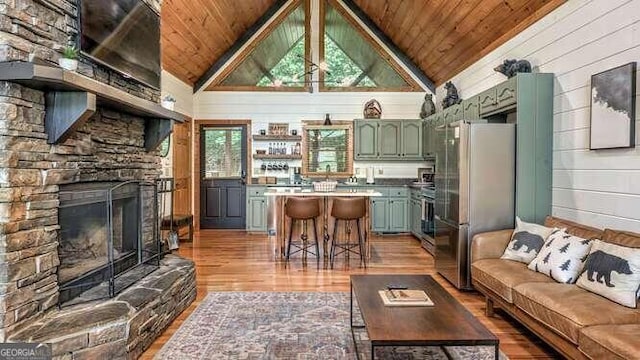 living room featuring wooden ceiling, a fireplace, and a healthy amount of sunlight