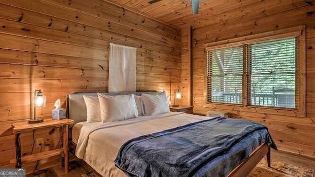 bedroom featuring hardwood / wood-style floors, wood walls, and wood ceiling