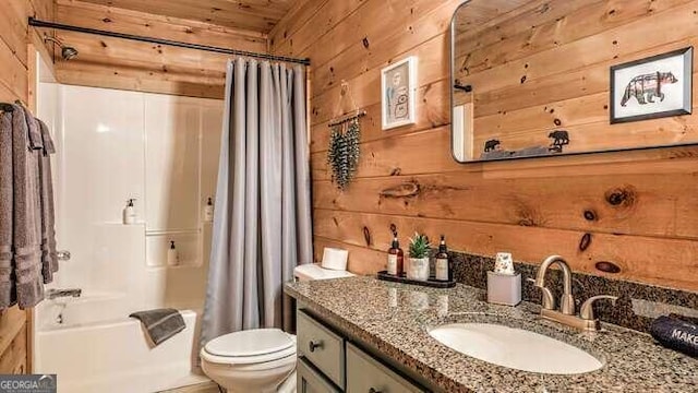 full bathroom featuring shower / bath combo, wood walls, toilet, and vanity