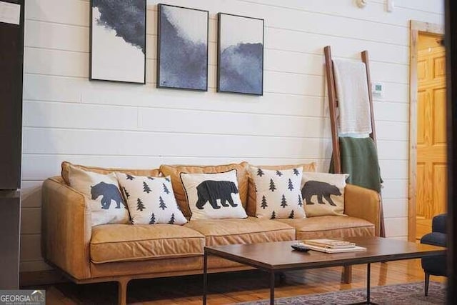 mudroom featuring wood walls and hardwood / wood-style flooring