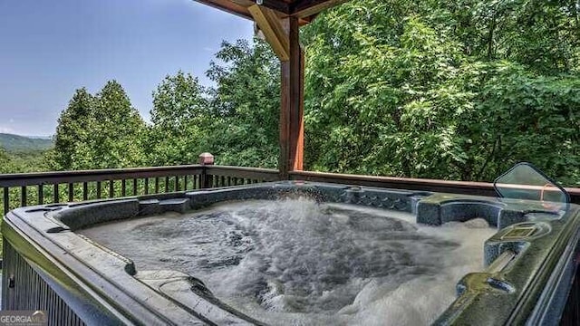 deck featuring a hot tub