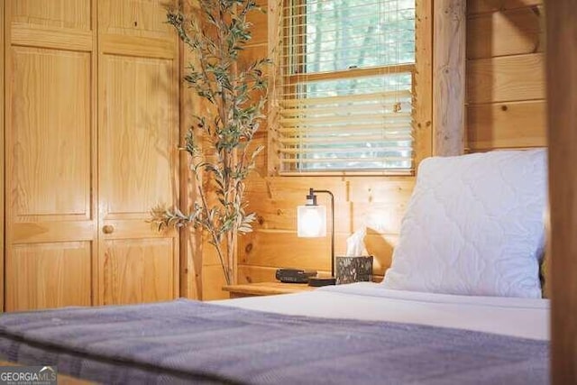 bedroom with wooden walls and a closet