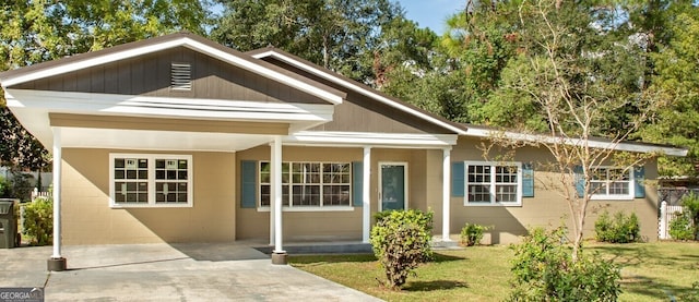 view of front of property with a front lawn and a carport