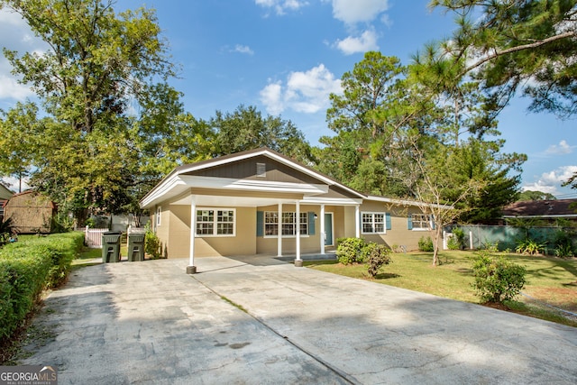 ranch-style house with a porch and a front yard