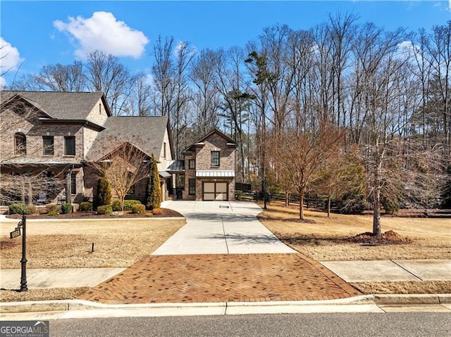 view of front of home with driveway and brick siding