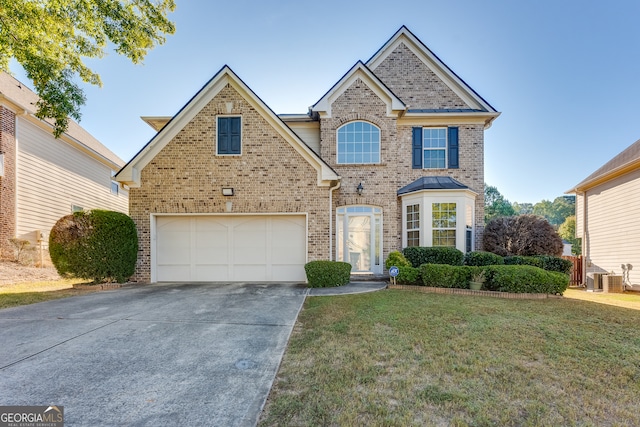 front of property featuring a garage and a front yard