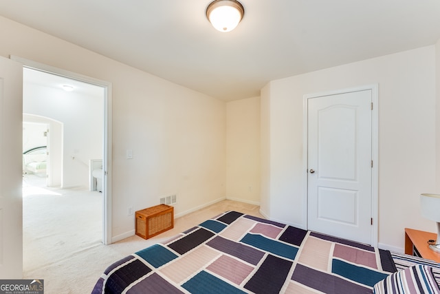 bedroom featuring light colored carpet