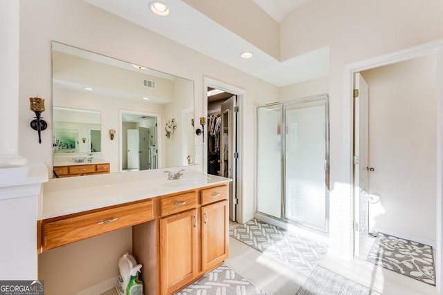 bathroom with vanity and a shower with door