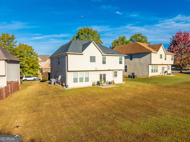 rear view of property with a patio area and a lawn