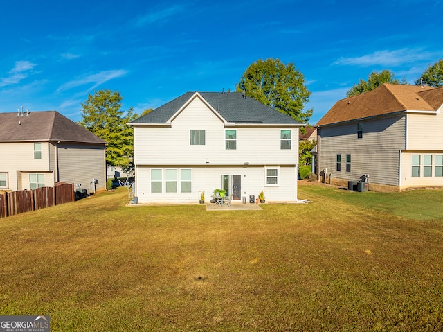 rear view of house featuring central AC unit, a patio area, and a lawn