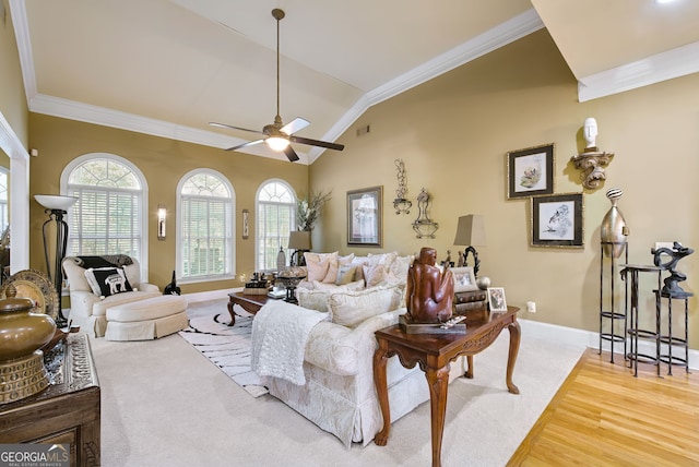 living room with ornamental molding, hardwood / wood-style floors, plenty of natural light, and vaulted ceiling