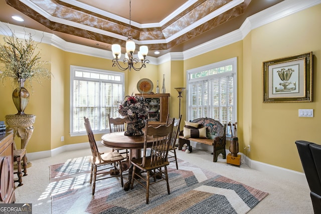 carpeted dining room featuring crown molding, a wealth of natural light, and a raised ceiling