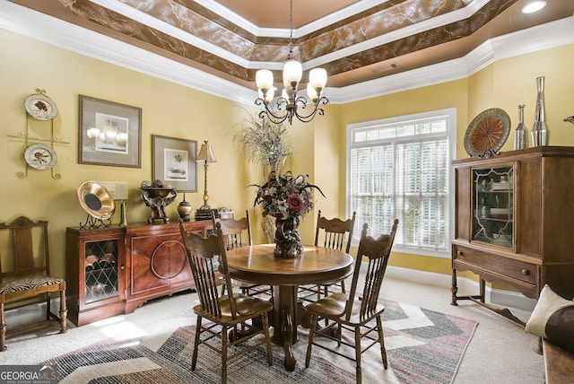 carpeted dining room with a chandelier, crown molding, and a raised ceiling