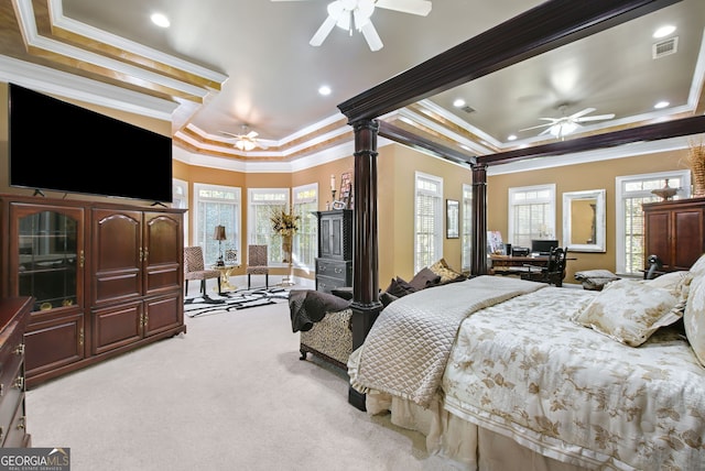 bedroom with ornamental molding, light carpet, ceiling fan, and a tray ceiling