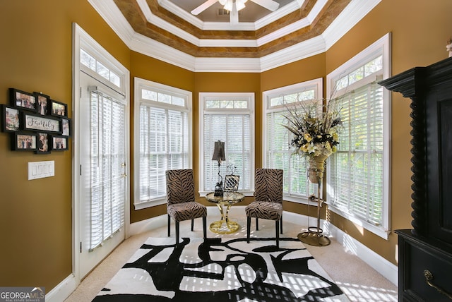 living area featuring crown molding, plenty of natural light, and light colored carpet