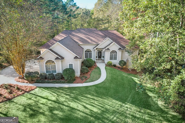 ranch-style home featuring a front yard