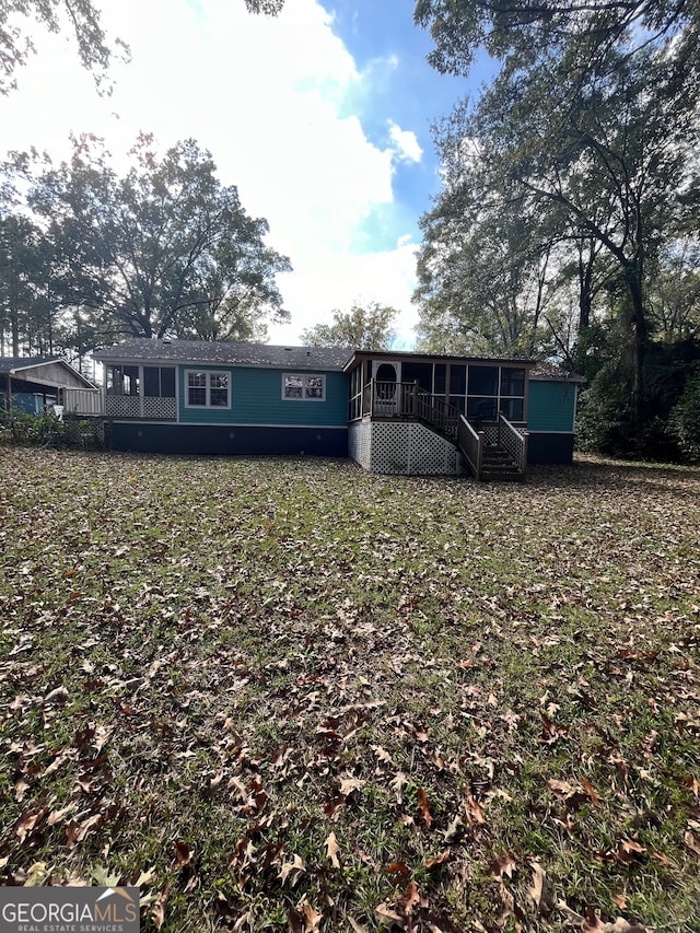 rear view of property with a sunroom