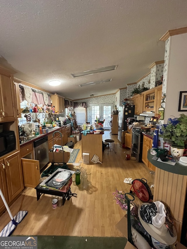 misc room featuring light hardwood / wood-style flooring, a textured ceiling, crown molding, and vaulted ceiling