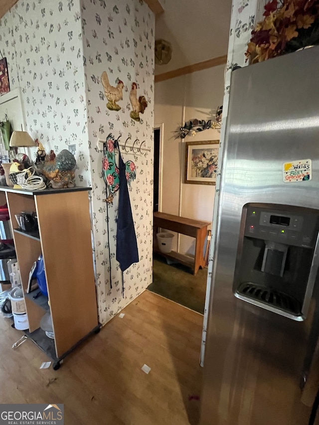 kitchen featuring hardwood / wood-style flooring and stainless steel fridge