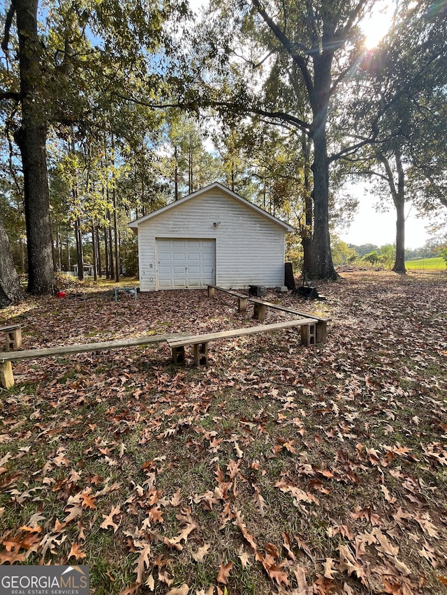 view of home's exterior featuring a garage and an outdoor structure