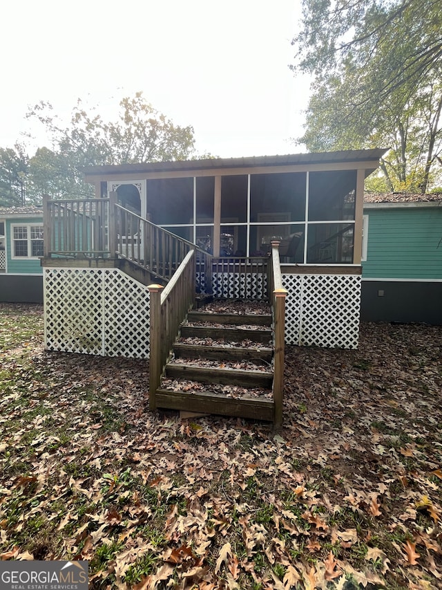 back of property featuring a sunroom