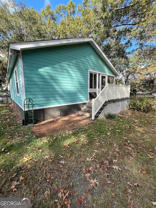 view of side of home with a deck