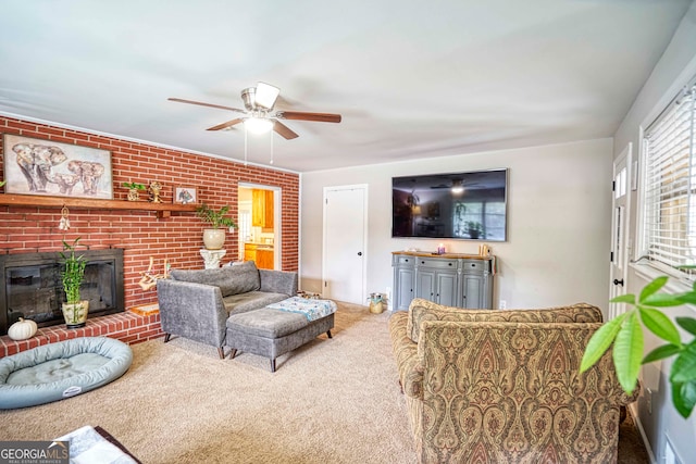 living room with a brick fireplace, carpet floors, ceiling fan, and brick wall