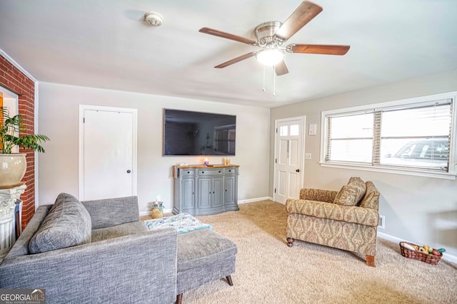 living room featuring light colored carpet, ceiling fan, and a fireplace