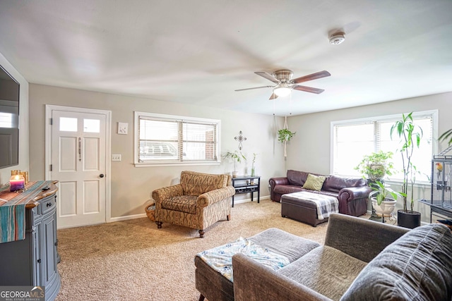 carpeted living room with ceiling fan