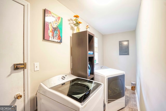 washroom featuring light wood-type flooring and separate washer and dryer